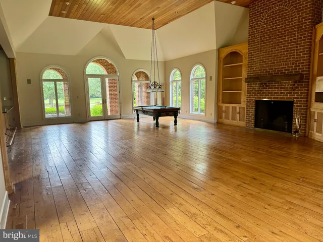 a view of a room with window and wooden floor