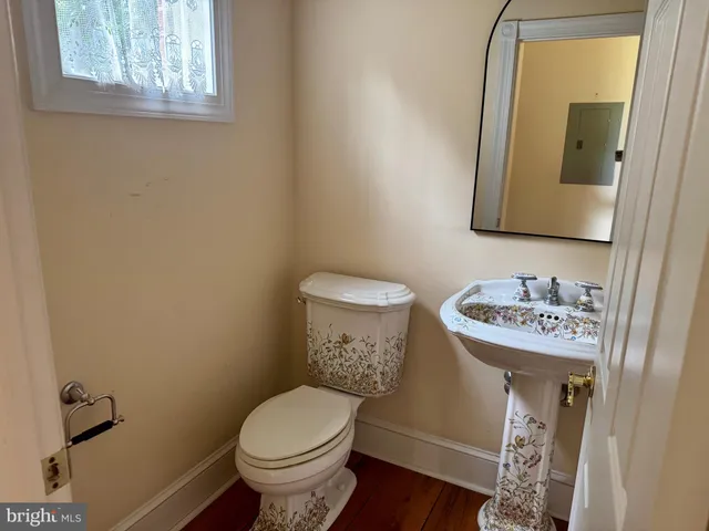 an empty room with windows and fireplace