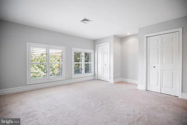 a bathroom with a double vanity sink toilet and shower