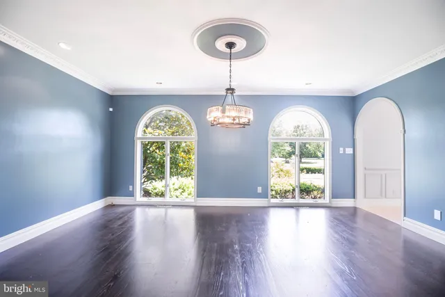 a view of a livingroom with furniture and a large window