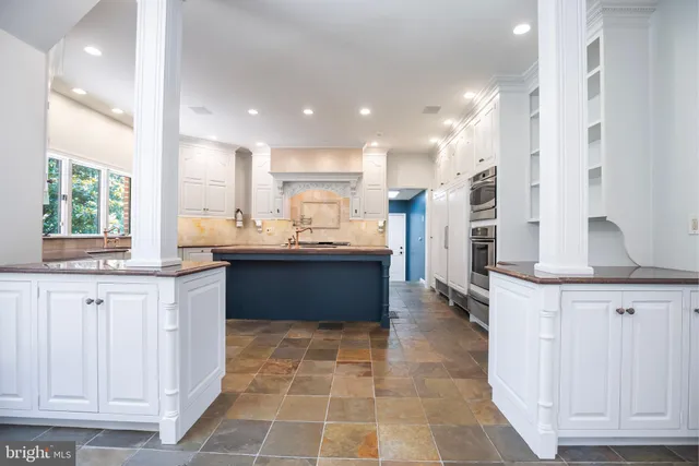 a view of a kitchen with windows and refrigerator