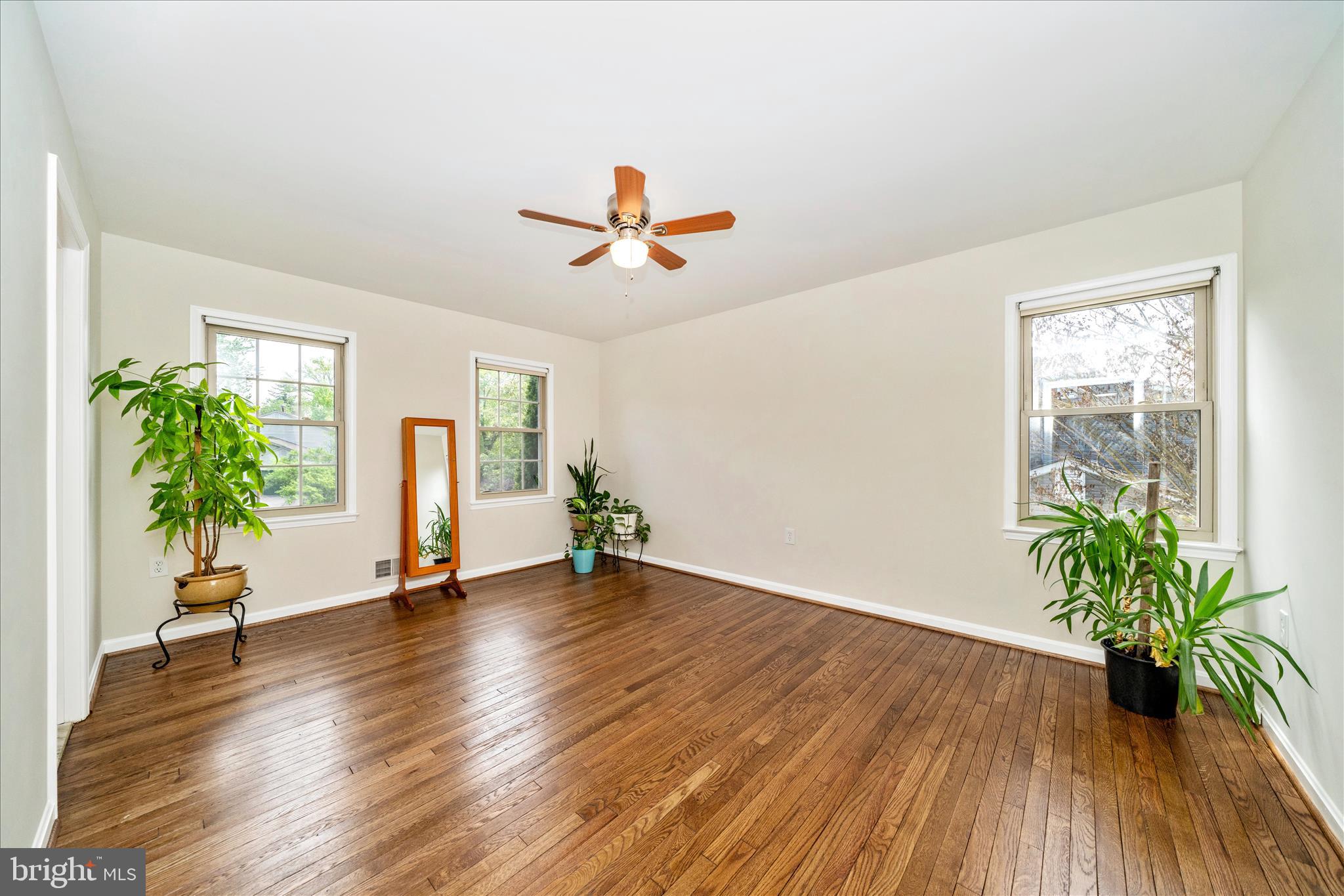 16000 Narrows Terrace Silver Spring, MD 20906 - Photo 22 of 54 a view of an empty room with window and wooden floor