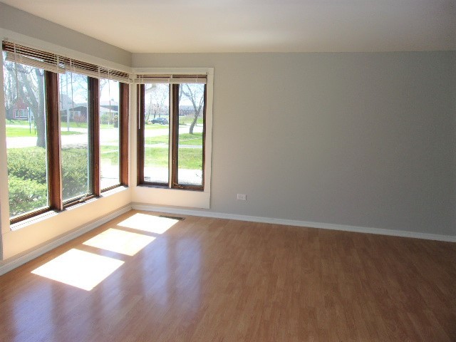 3936 169th Street Country Club Hills, IL 60478 - Photo 4 of 11 a view of an empty room with wooden floor and a window
