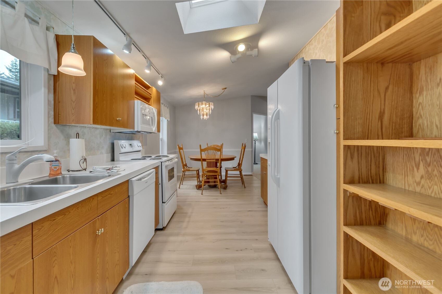2200 196th Street Southeast, Unit 66 Bothell, WA 98012 - Photo 11 of 26 a kitchen with a sink and chairs