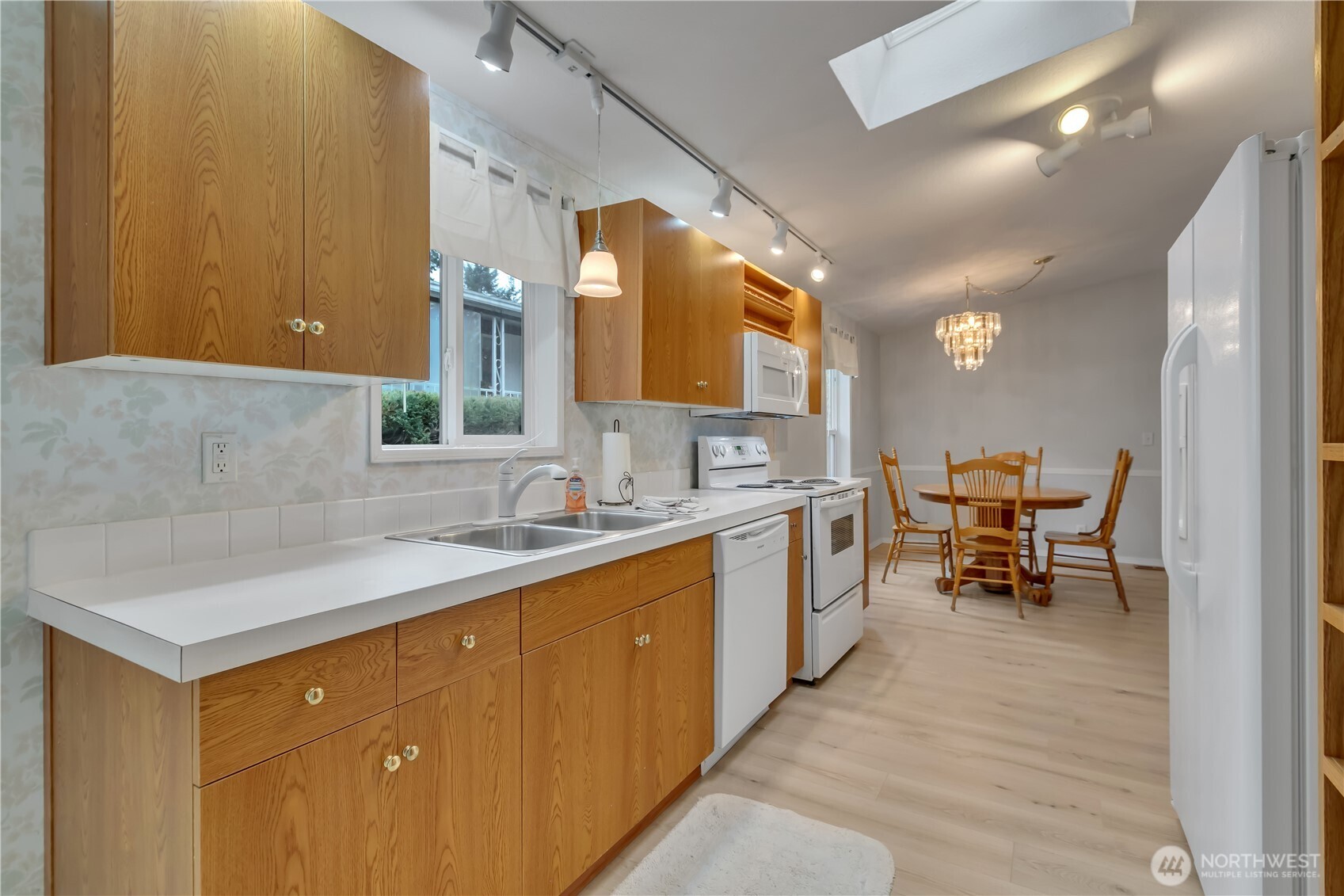 2200 196th Street Southeast, Unit 66 Bothell, WA 98012 - Photo 12 of 26 a kitchen with a sink and chairs