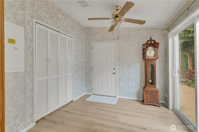 a room that has a mirror and a wooden floor