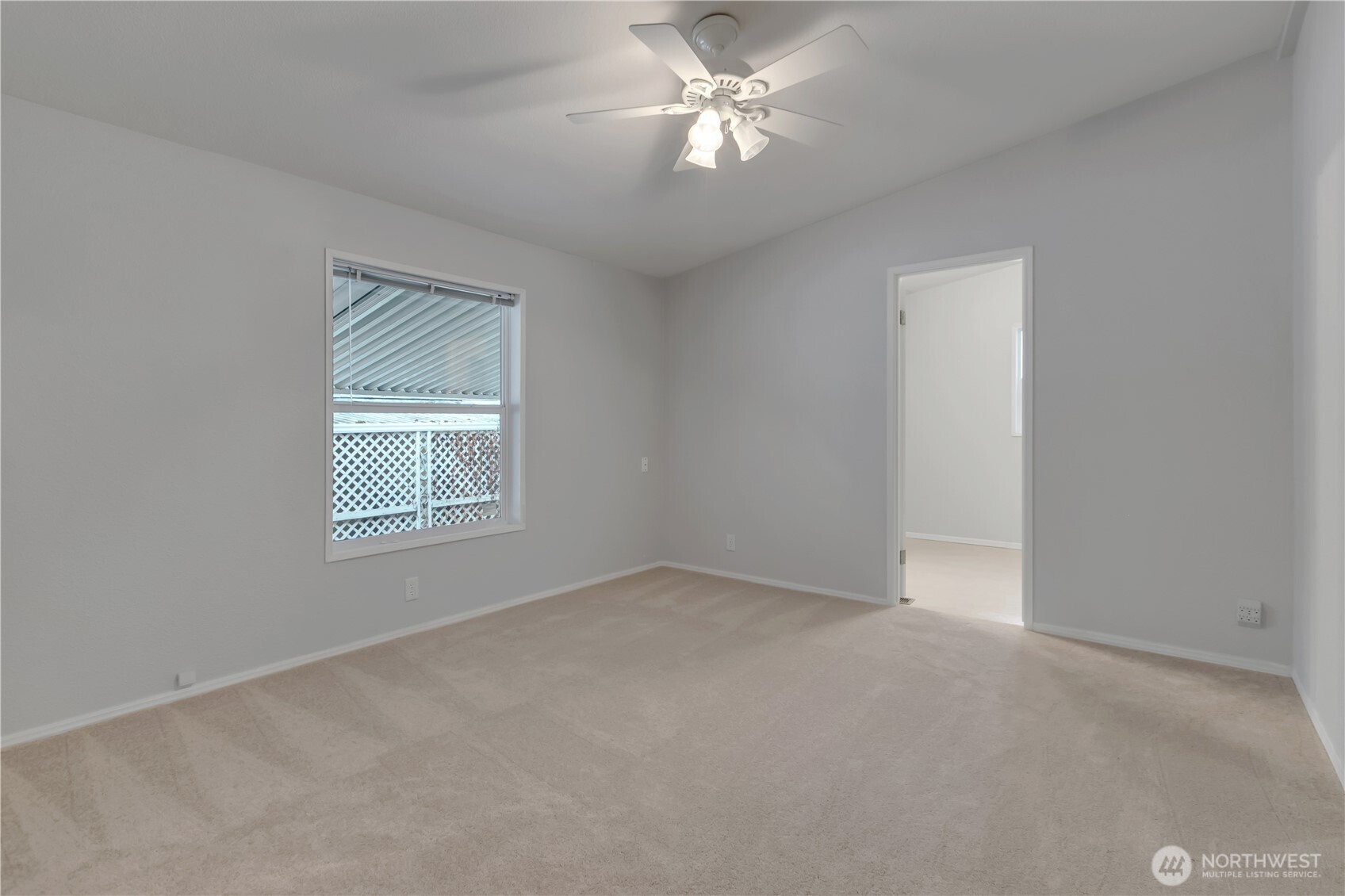 2200 196th Street Southeast, Unit 66 Bothell, WA 98012 - Photo 15 of 26 an empty room with a window and a fan