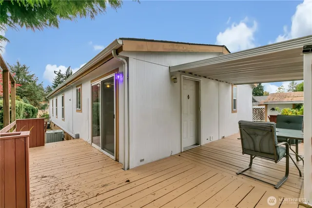 a front view of house with deck and outdoor seating