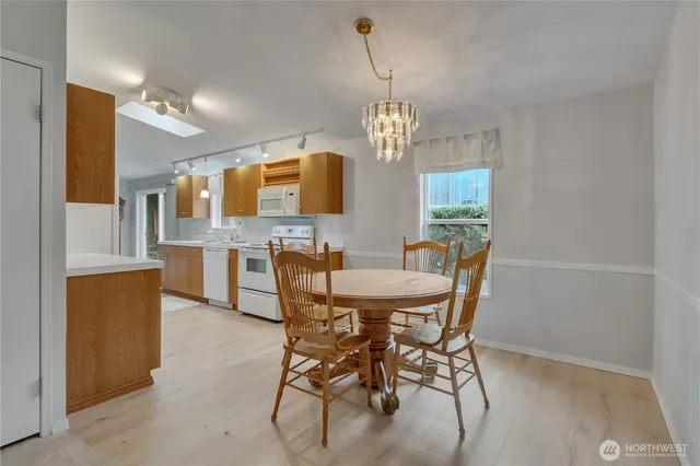 a view of a dining room with furniture and chandelier
