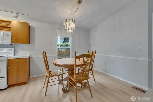 a view of a dining room with furniture and a chandelier