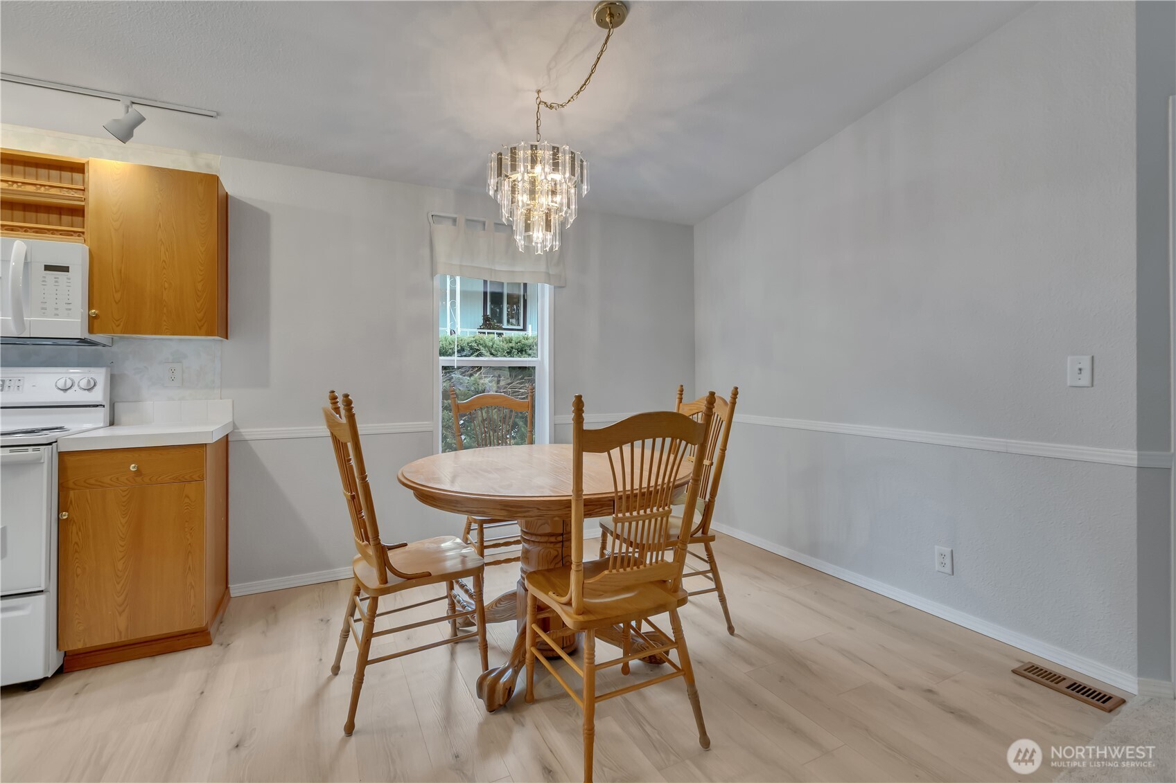 2200 196th Street Southeast, Unit 66 Bothell, WA 98012 - Photo 7 of 26 a view of a dining room with furniture and a chandelier