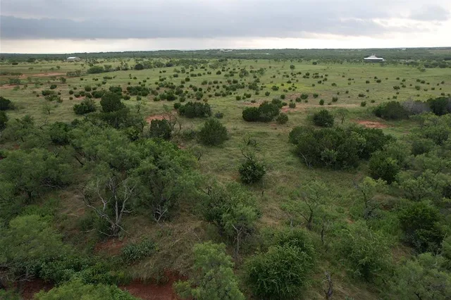 an aerial view of houses with yard