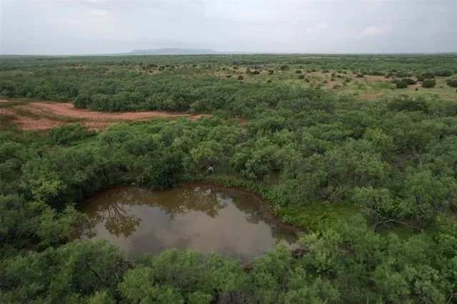 a view of a lake with green field
