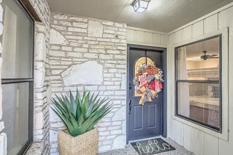 a vase of flowers sitting on a table in front of a door
