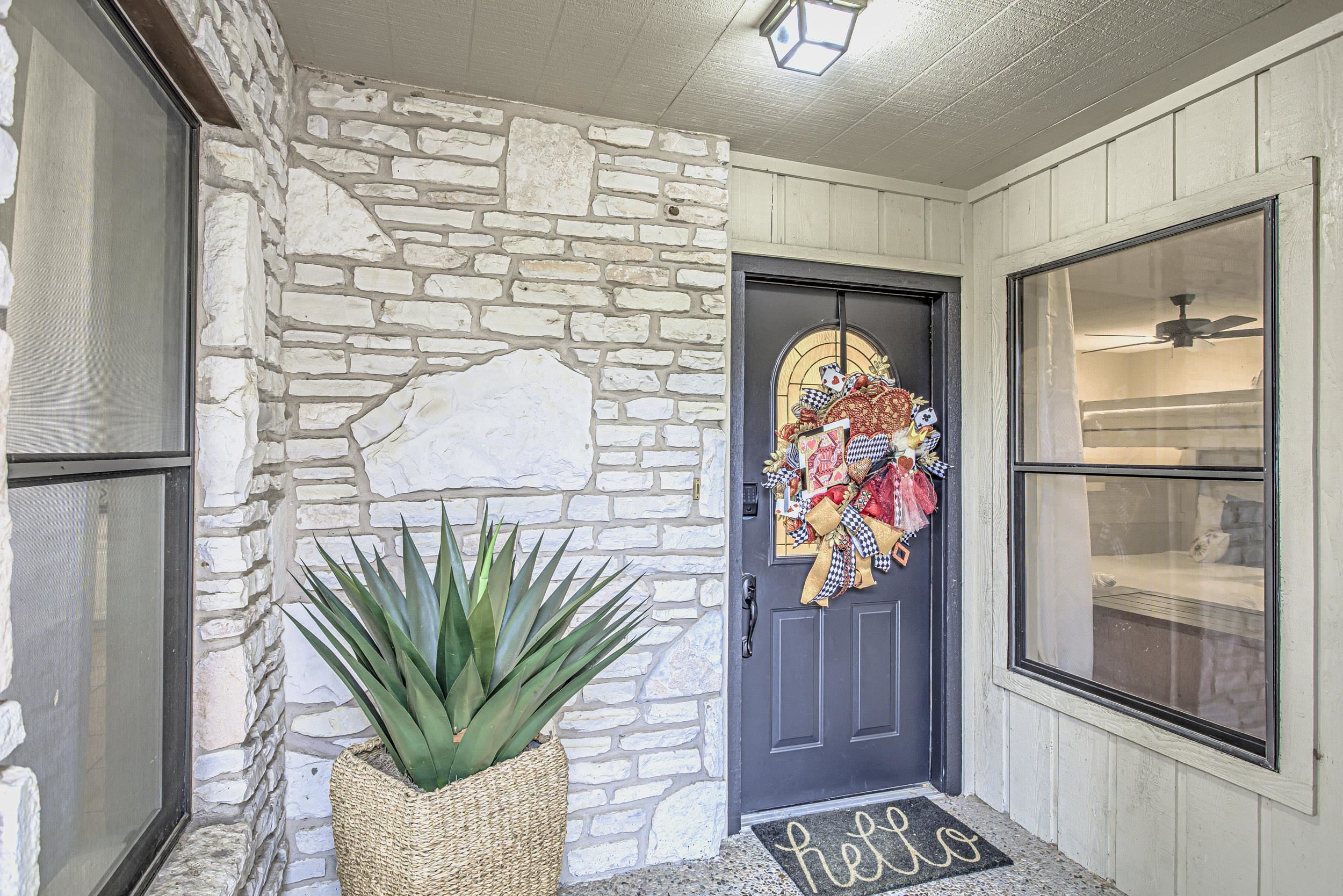 a vase of flowers sitting on a table in front of a door
