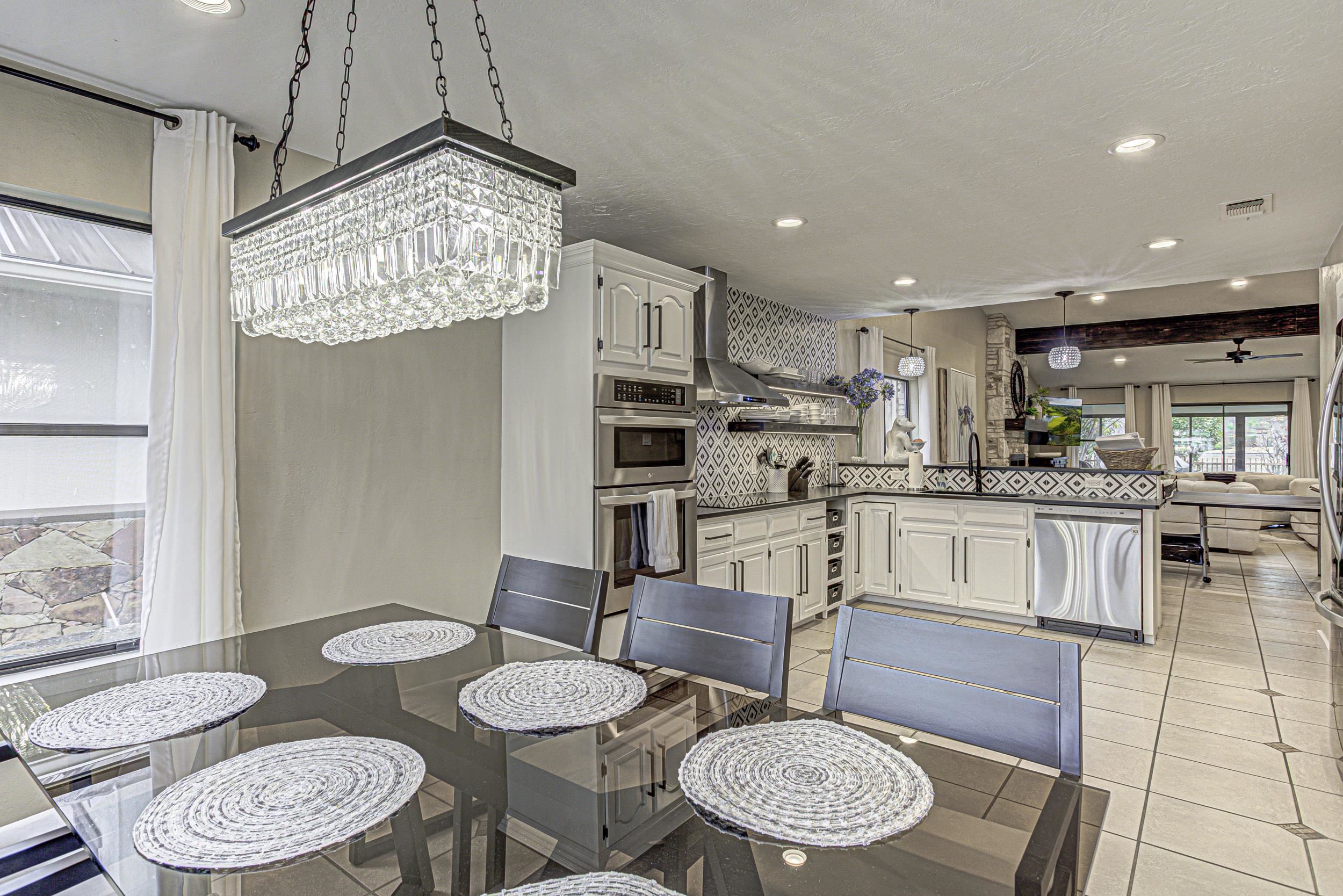 103 Oasis, Unit A Horseshoe Bay, TX 78657 - Photo 11 of 30 a kitchen with a dining table and chairs