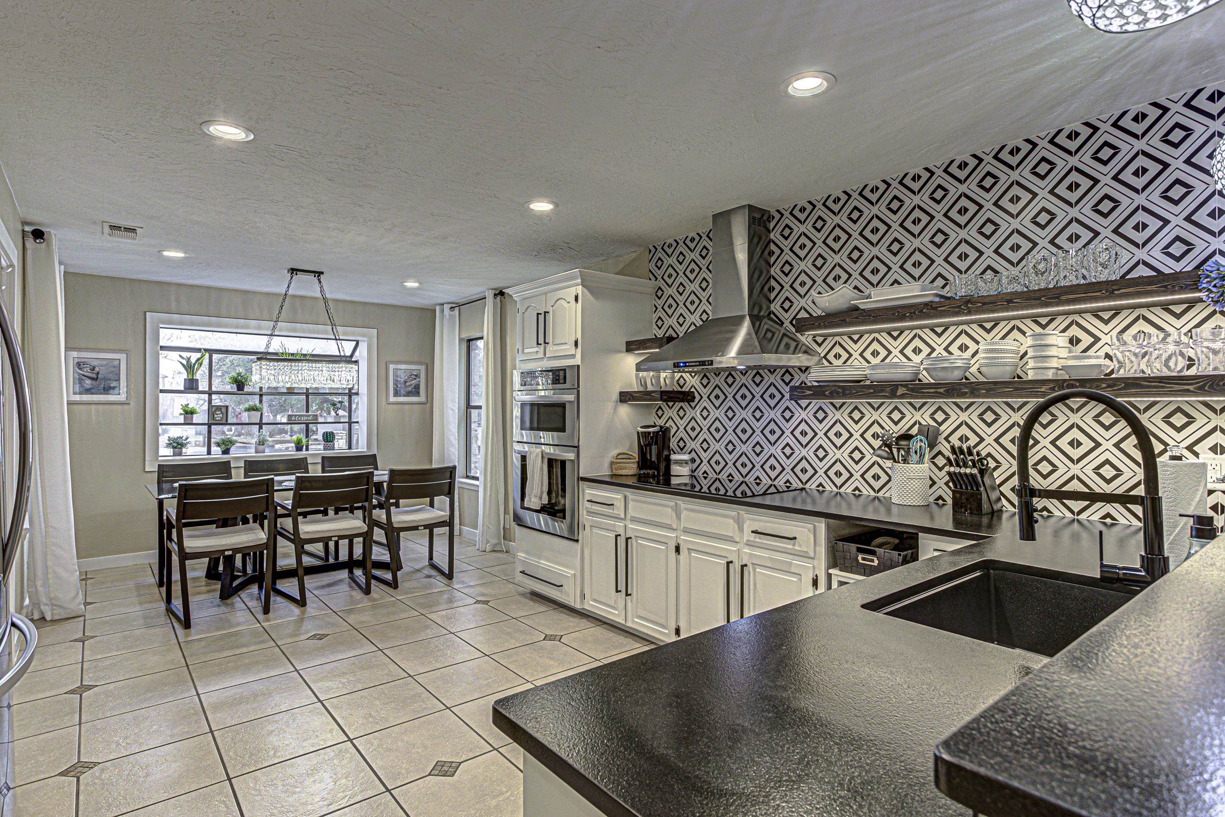 103 Oasis, Unit A Horseshoe Bay, TX 78657 - Photo 13 of 30 a kitchen with stainless steel appliances granite countertop a sink and a white cabinets