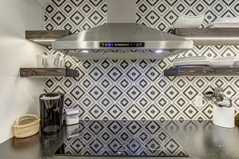 a bathroom with a stove and a shower