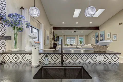 a view of hall way with furniture and chandelier