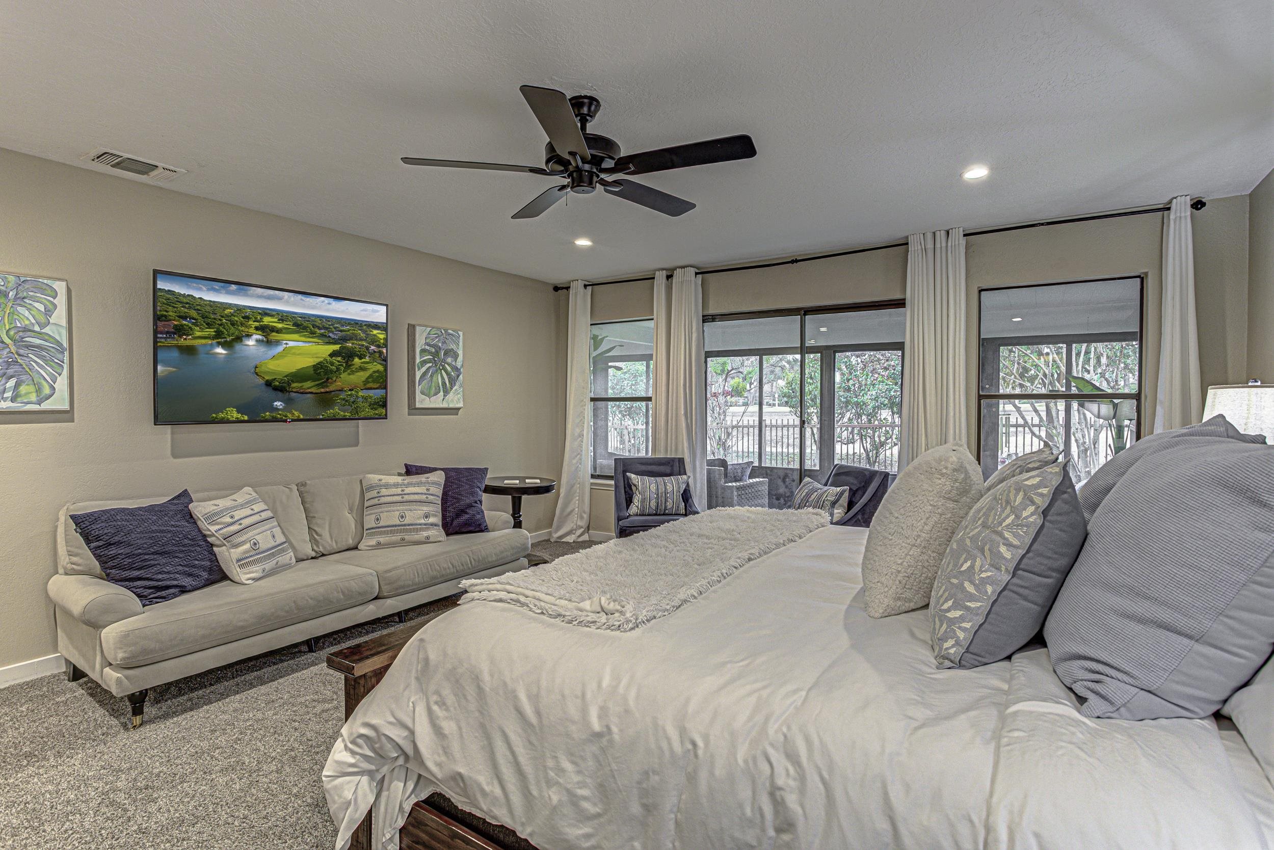 103 Oasis, Unit A Horseshoe Bay, TX 78657 - Photo 18 of 30 a bedroom with a large bed couch and window