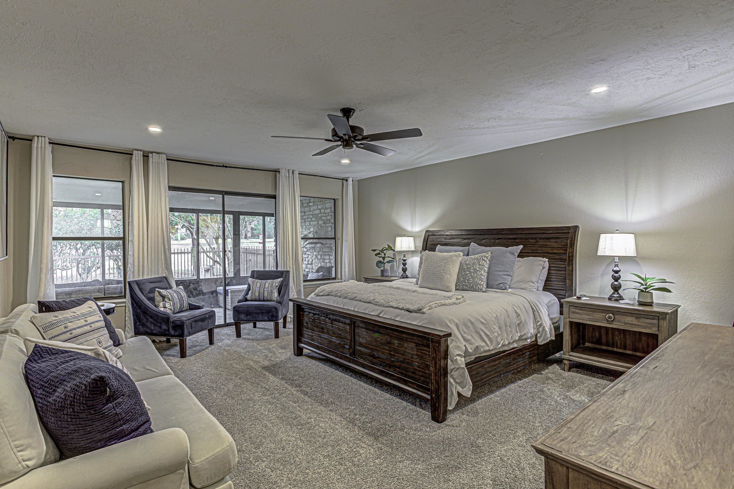 103 Oasis, Unit A Horseshoe Bay, TX 78657 - Photo 19 of 30 a spacious bedroom with a bed and glass windows