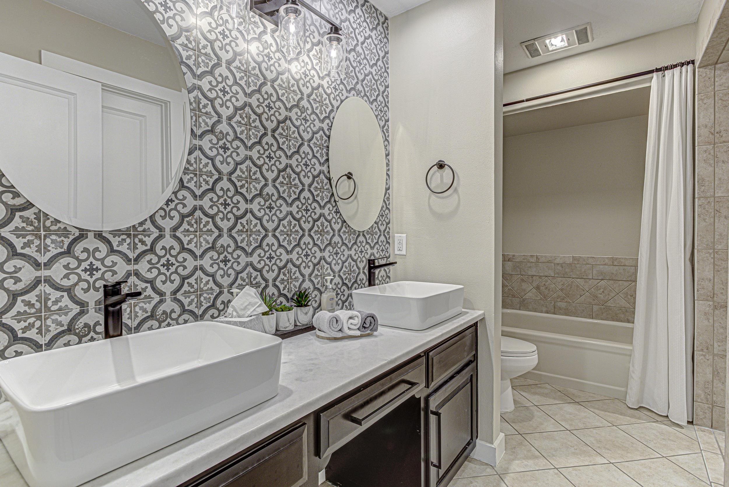 103 Oasis, Unit A Horseshoe Bay, TX 78657 - Photo 20 of 30 a bathroom with a sink and a mirror