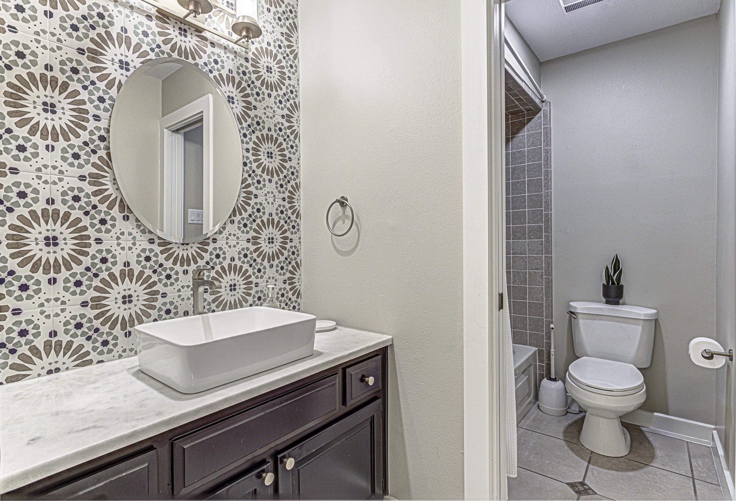 103 Oasis, Unit A Horseshoe Bay, TX 78657 - Photo 25 of 30 a bathroom with a toilet sink and mirror