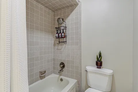 a bathroom with a sink a toilet and bathtub