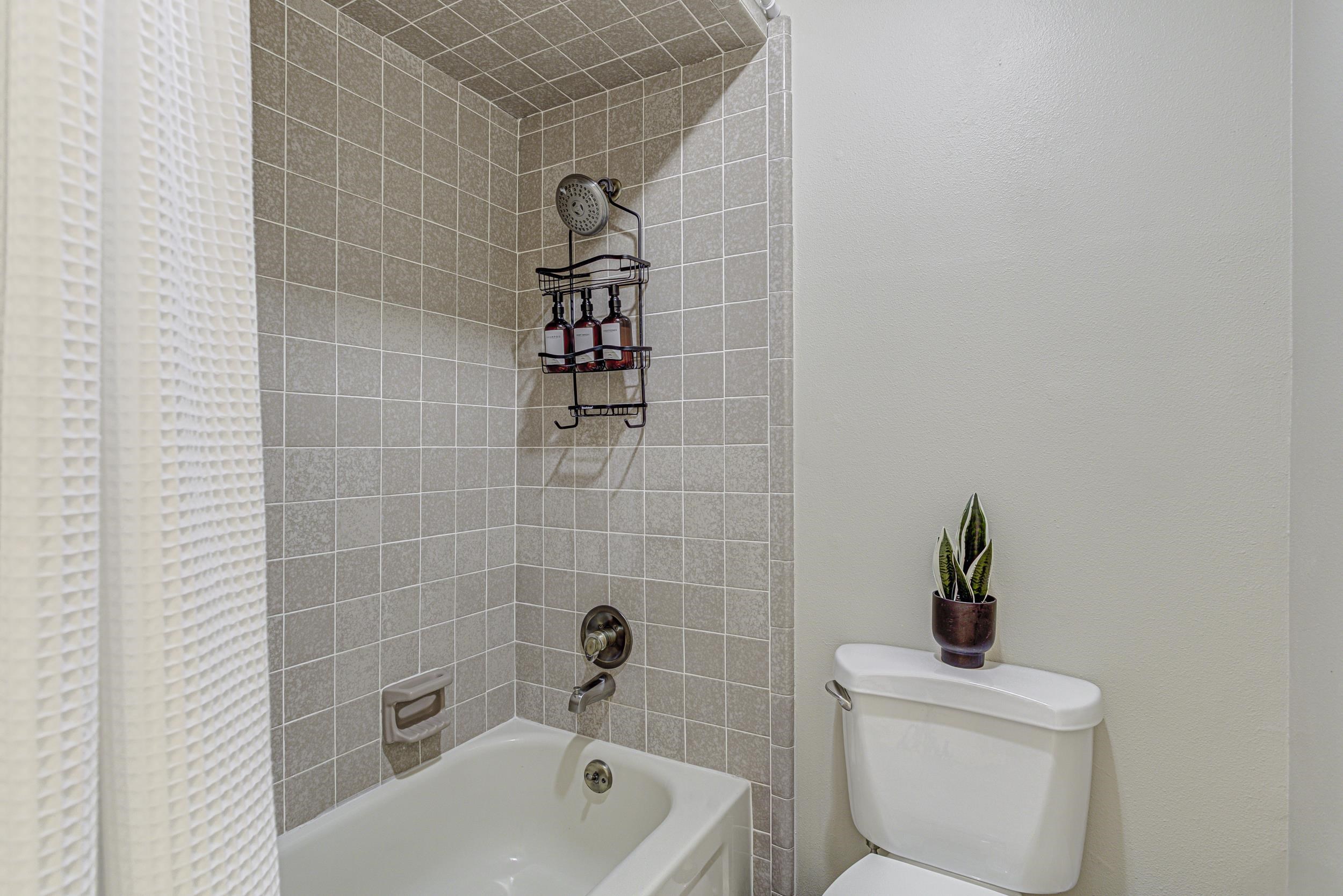 103 Oasis, Unit A Horseshoe Bay, TX 78657 - Photo 26 of 30 a bathroom with a sink a toilet and bathtub