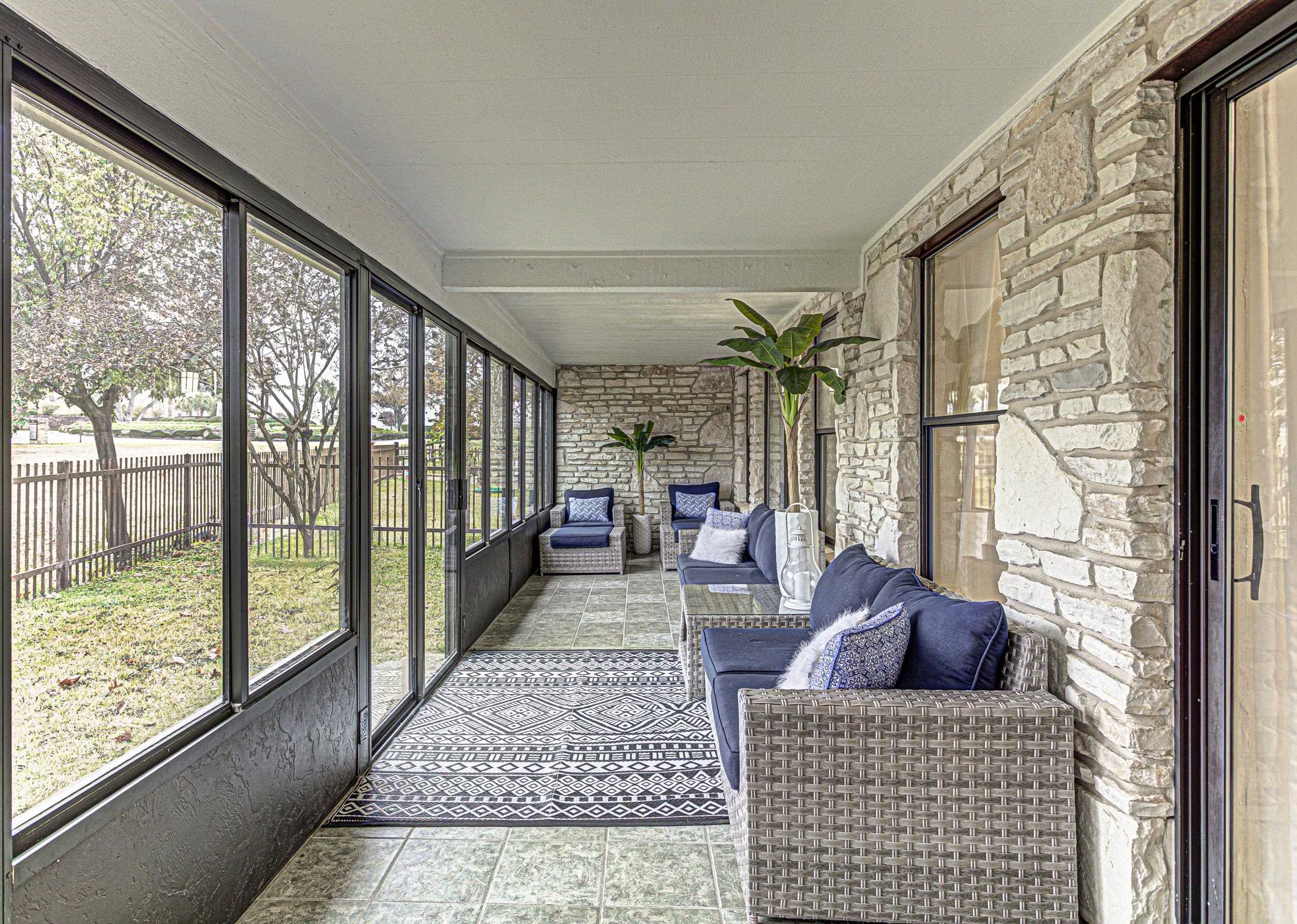 103 Oasis, Unit A Horseshoe Bay, TX 78657 - Photo 27 of 30 a living room with furniture and a floor to ceiling window
