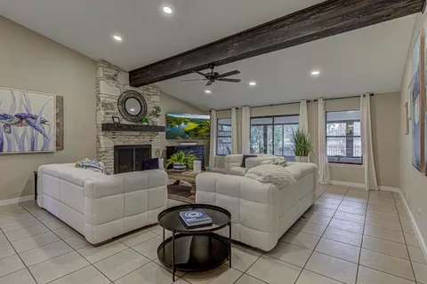 a living room with furniture a fireplace and a flat screen tv