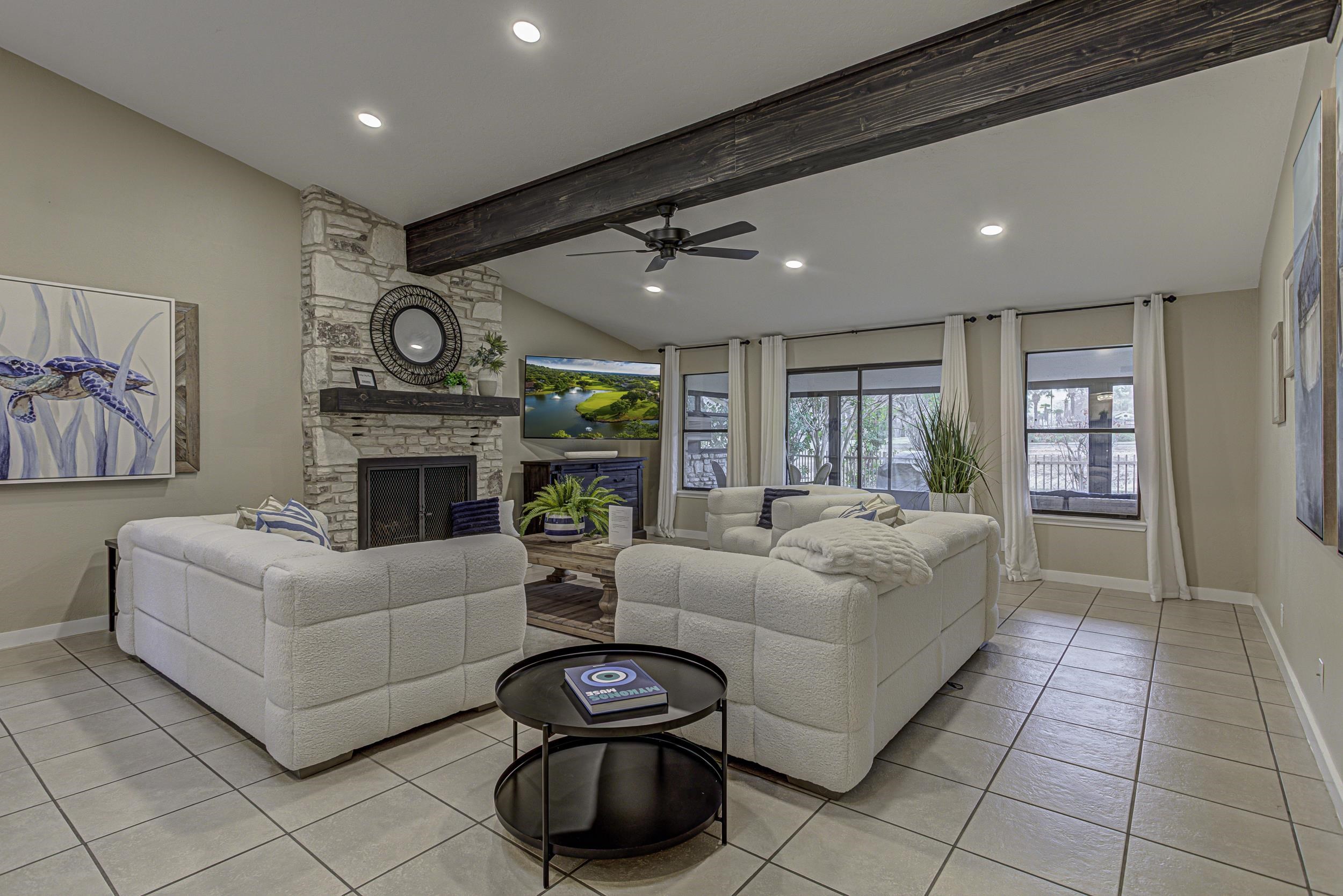 103 Oasis, Unit A Horseshoe Bay, TX 78657 - Photo 4 of 30 a living room with furniture a fireplace and a flat screen tv