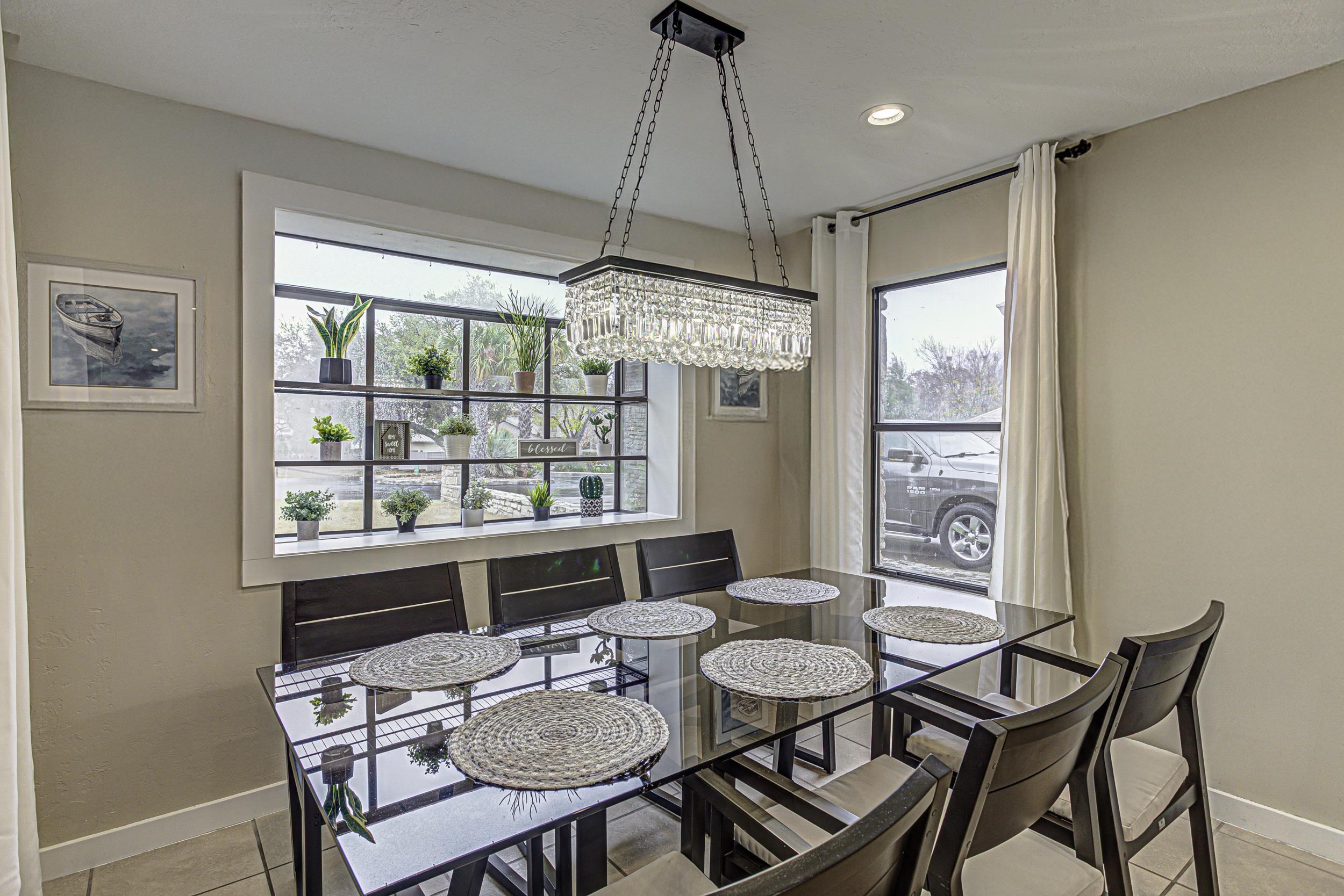 103 Oasis, Unit A Horseshoe Bay, TX 78657 - Photo 10 of 30 a dining room with furniture a chandelier and window