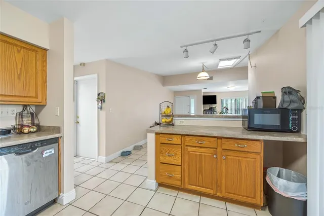 a front view of a house with a garden and trees