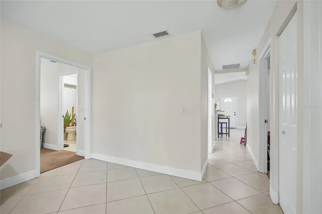 a living room with furniture and a dining table with kitchen view
