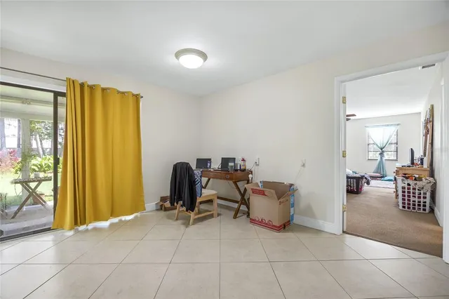 a living room with furniture a flat screen tv and a potted plant