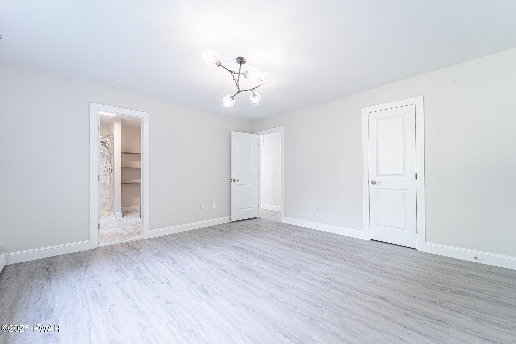 153 Hatton Road Hawley, PA 18428 - Photo 14 of 38 an empty room with wooden floor and windows