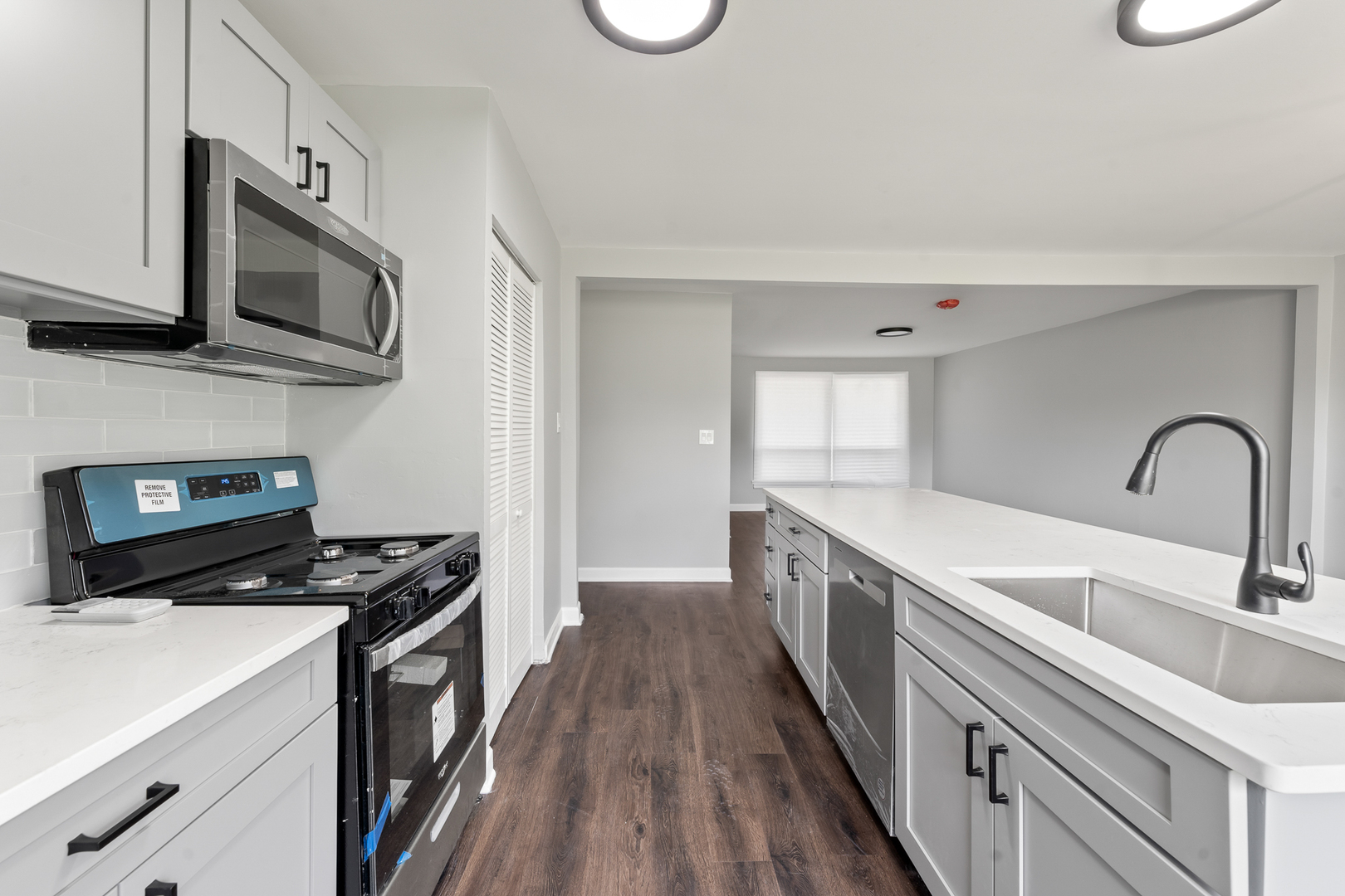 Undisclosed Address Hazel Crest, IL 60429 - Photo 11 of 23 a kitchen with stainless steel appliances a sink dishwasher a stove top oven a refrigerator with wooden floor and cabinets