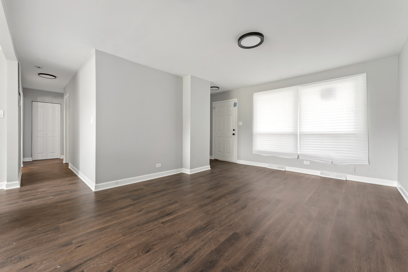 Undisclosed Address Hazel Crest, IL 60429 - Photo 3 of 23 a view of an empty room with wooden floor and a window