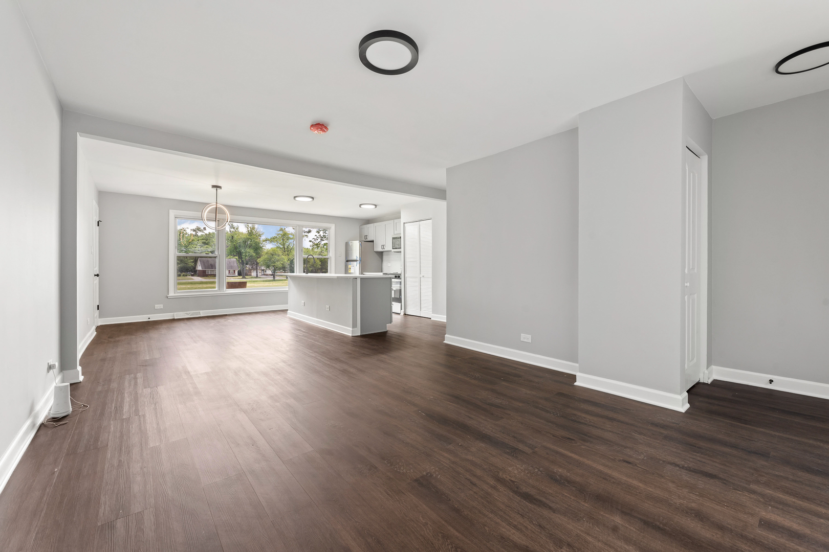 Undisclosed Address Hazel Crest, IL 60429 - Photo 4 of 23 a view of an empty room with wooden floor and a window