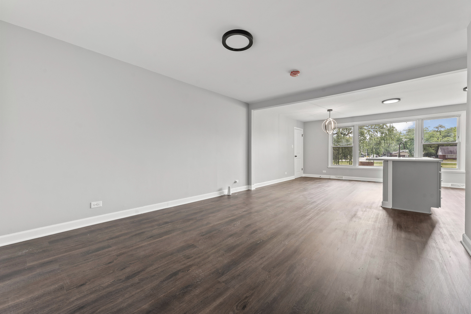 Undisclosed Address Hazel Crest, IL 60429 - Photo 5 of 23 a view of an empty room with wooden floor and a window