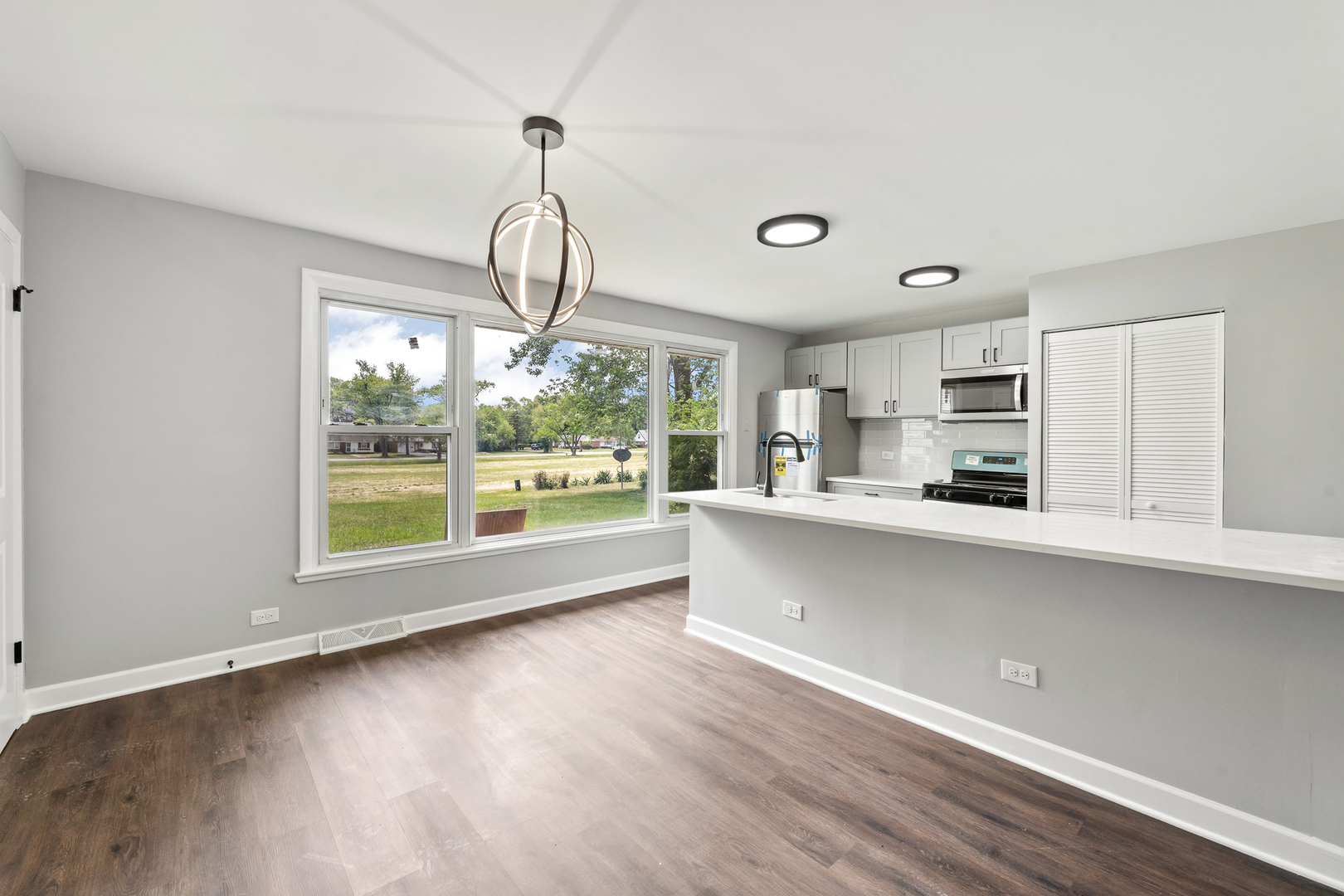 Undisclosed Address Hazel Crest, IL 60429 - Photo 8 of 23 a open kitchen with stainless steel appliances granite countertop a dishwasher a stove a refrigerator with white cabinets and wooden floor