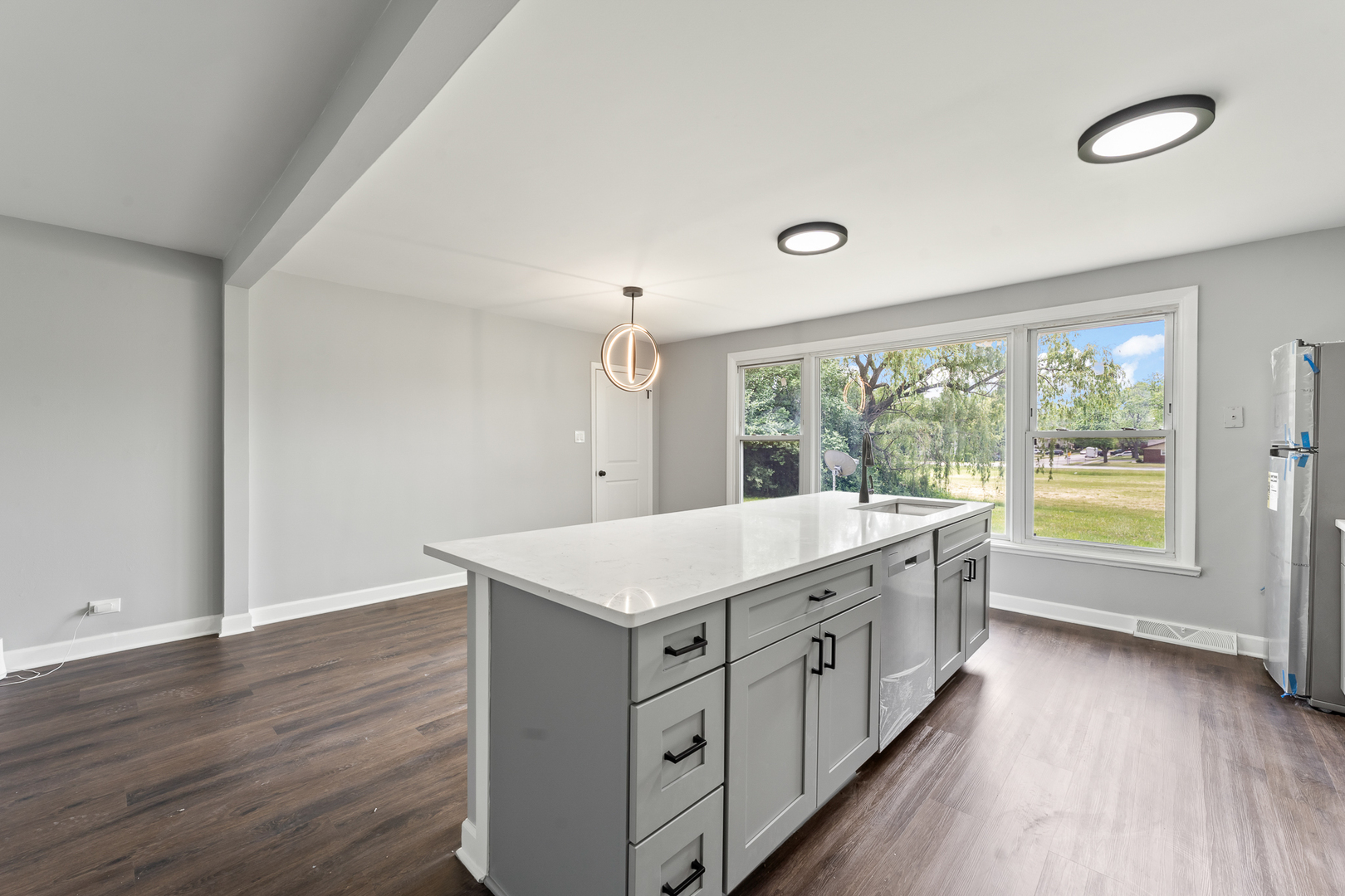 Undisclosed Address Hazel Crest, IL 60429 - Photo 9 of 23 a kitchen with white cabinets and wooden floors