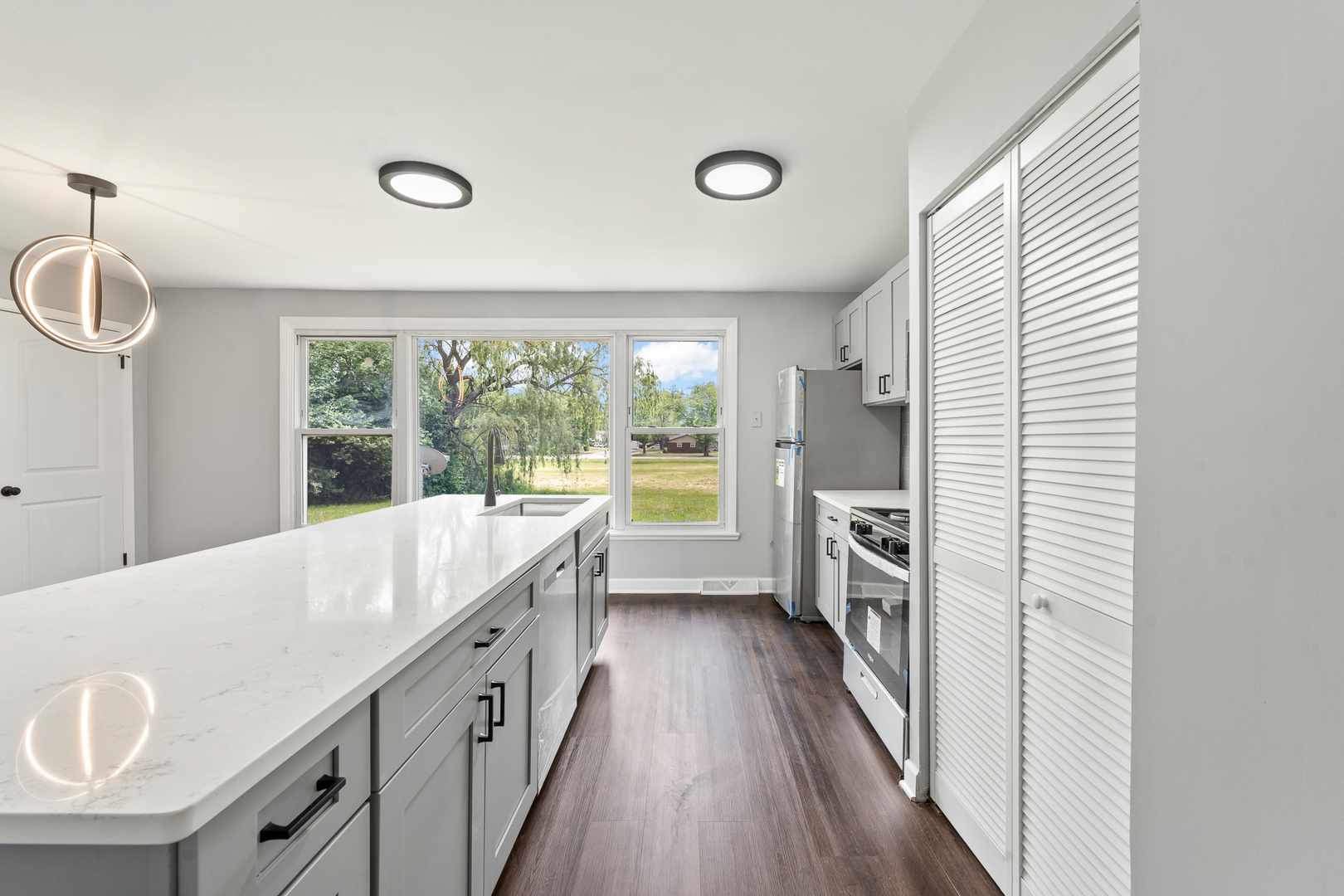 Undisclosed Address Hazel Crest, IL 60429 - Photo 10 of 23 a large white kitchen with a window and refrigerator