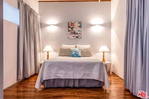 a living room with furniture a rug and a large window