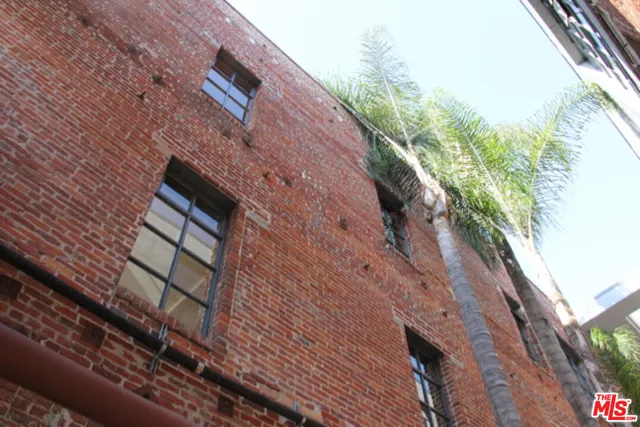 a view of a living room with furniture and wooden floor