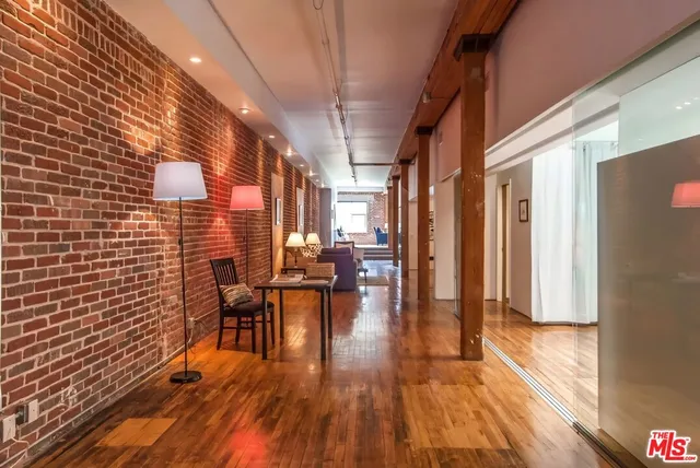 a view of a balcony with furniture and wooden floor