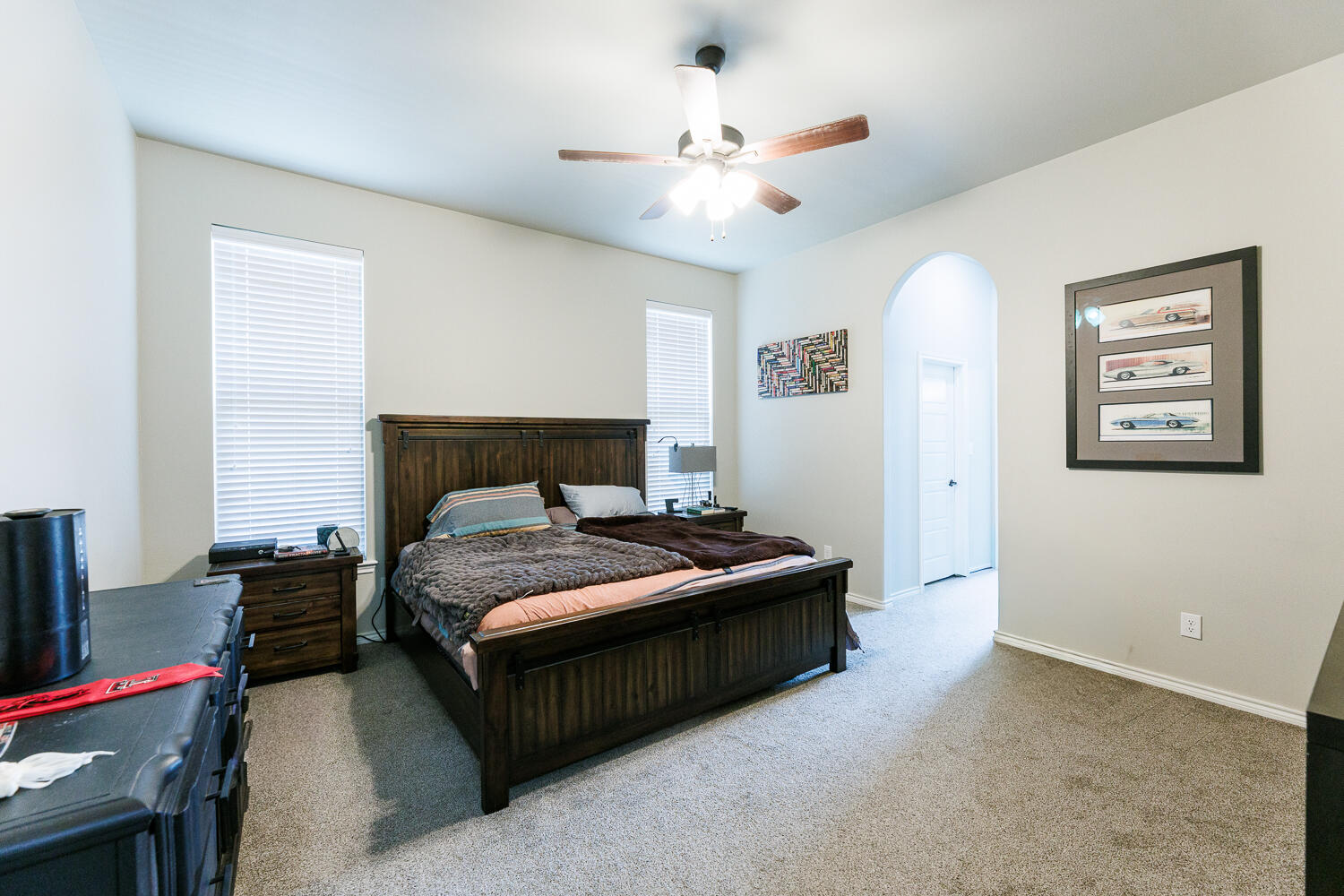 7619 59th Street Lubbock, TX 79407 - Photo 16 of 33 a bedroom with a bed chandelier and a window