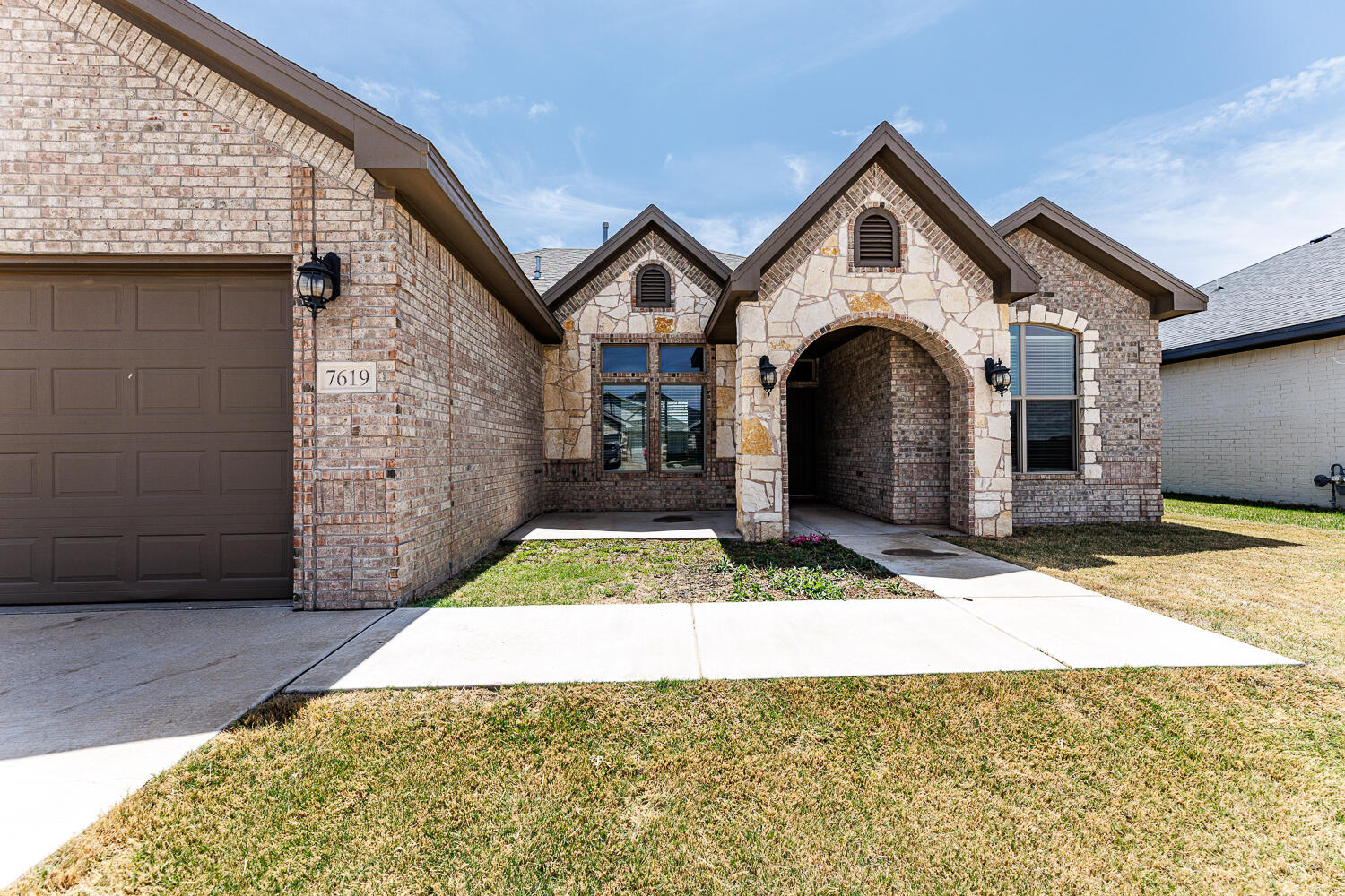 7619 59th Street Lubbock, TX 79407 - Photo 2 of 33 a front view of a house with a yard