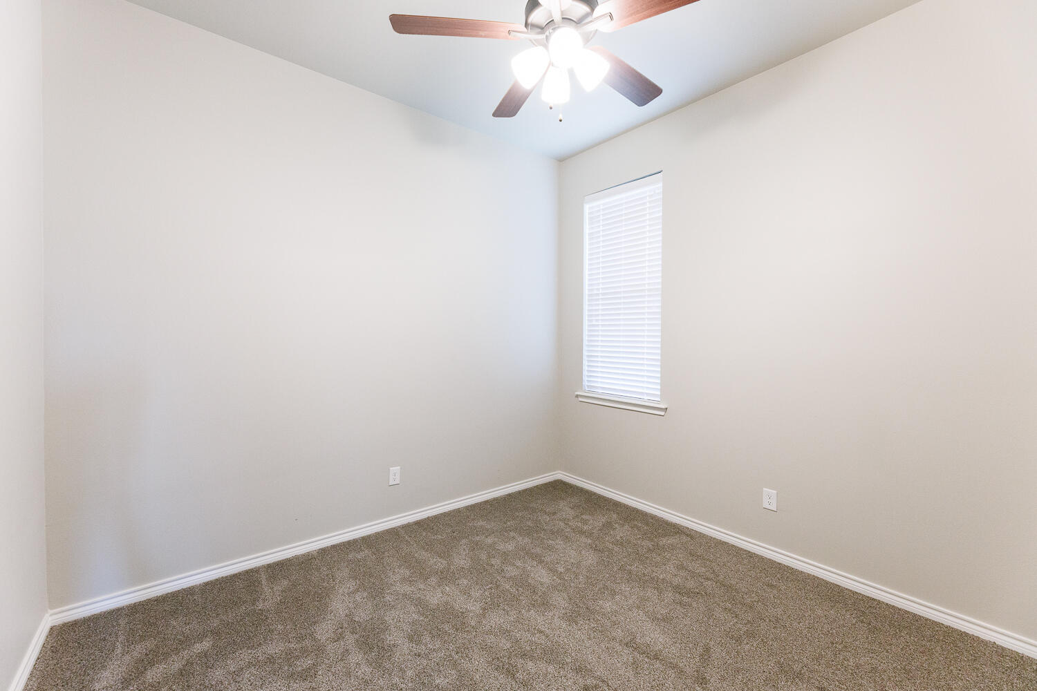 7619 59th Street Lubbock, TX 79407 - Photo 25 of 33 an empty room with a window and a chandelier fan